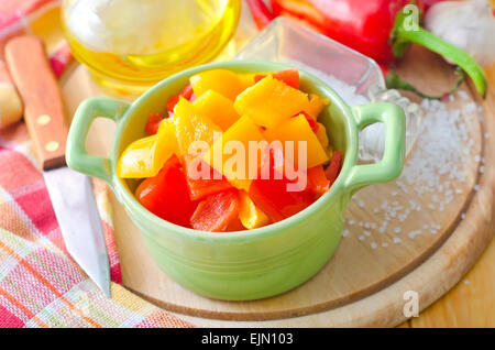 Yellow and red peppers on wooden background Stock Photo