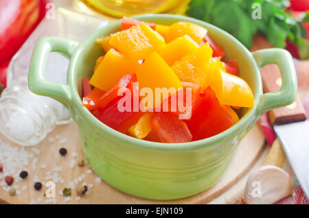 red and yellow peppers on wooden background Stock Photo