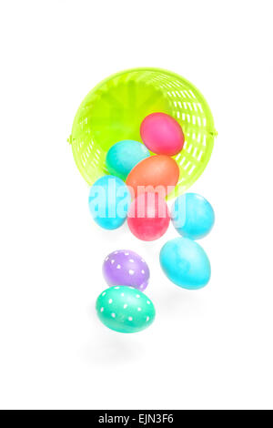 Easter eggs falling out of basket isolated on white (with shadow) Stock Photo