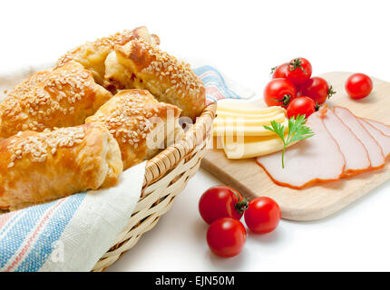 Puff pastry patties with cheese ham sesame and cherry tomatoes. Stock Photo
