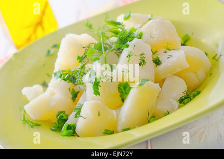 boiled potato with greens in the green plate Stock Photo