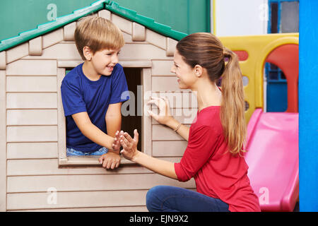 Happy mother and son playing a clapping game in nursery at home Stock Photo