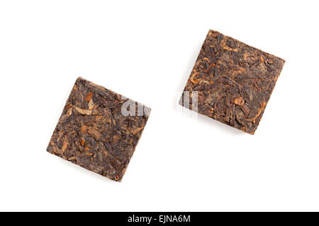 Two small briquette of black Chinese Shu Pu-erh tea isolated on white background, top view Stock Photo
