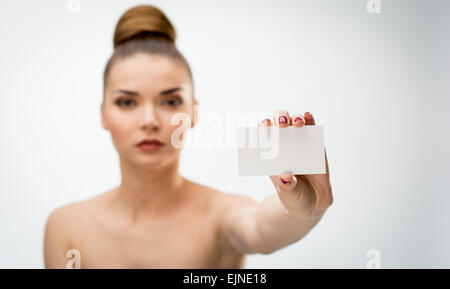 Beautiful woman holding a blank card Stock Photo
