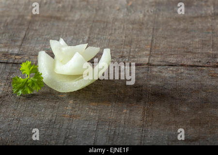 White Onion Slices and parsley on wooden board Stock Photo