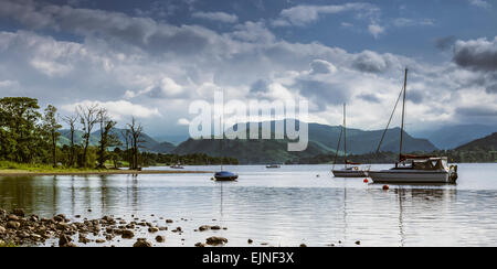 View from the Ullswater shore of sailing boats near Pooley Bridge with the Lake District fells in the background Stock Photo