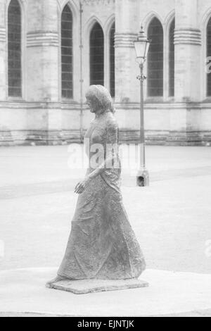 Walking Madonna statue and lamp in front of Salisbury Cathedral, Salisbury, Wilshire, UK in March Stock Photo