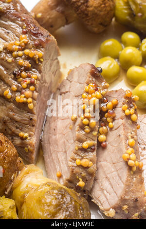 Cooking recipe or menu background. Roast beef with grilled sprouts and peas. Eco food image Stock Photo