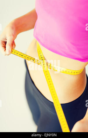 trained belly with measuring tape Stock Photo