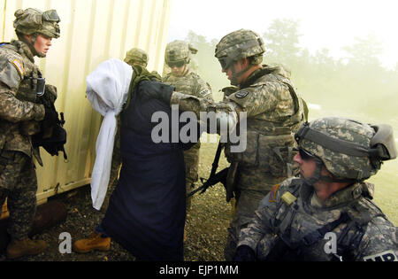 U.S. Army Soldiers from the 186th Military Police Company, Iowa Army National Guard detain a possible insurgent during military operations on urban terrain as part of mobilization training conducted by the 72nd Field Artillery Brigade at Fort Dix, N.J., Jan. 10, 2008.  Staff Sgt. Russell Lee Klika Released Stock Photo