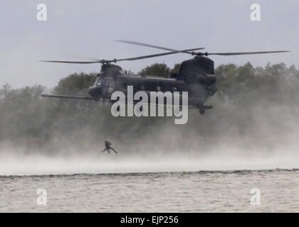 An U.S. Air Force Airman is hoisted from the water by an MH-47 Chinook helicopter from an MH-47 Chinook helicopter assigned to U.S. Army 160th Special Operations Aviation Regiment on Fort Fisher in Kure Beach, N.C., Sept. 19, 2007. Airmen and Soldiers from Hurlburt Field, Fla., and Fort Campbell, Ky., participated in the two-week long training.  Airman Matthew R. Loken Stock Photo