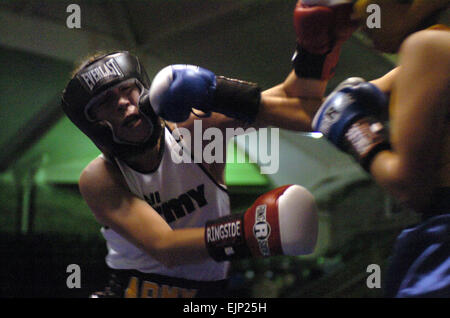 In one of two women's bouts on the 2008 Armed Forces Boxing Championships card, Army National Guard Sgt. Cherrie Retamozzo of Staten Island, N.Y., exchanges punches with UT2 Sonia Deputee of Naval Base Ventura County in Port Hueneme, Calif. Retamozzo won the bout, 34-11.  Tim Hipps, Family and MWR Command Stock Photo