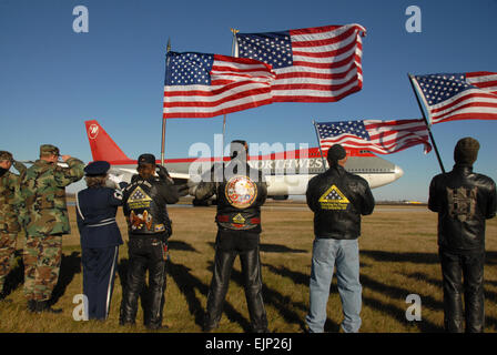 From left, North Dakota Air National Guardsmen, Patriot Guard motorcycle riders and North Dakota Army National Guardsmen salute and stand at attention as a plane carrying retired veterans to Washington, D.C., to tour the National World War II Memorial departs Hector International Airport in Fargo, N.D., Nov. 2, 2007. U.S. Air Force Senior Master Sgt. David H. Lipp Released Stock Photo