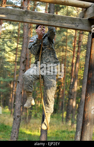 First Lt. Jeremy Gilbert, assigned to 2nd Cavalry Regiment goes through the obstacle course during U.S. Army Europe's Best Junior Officer Competition in Grafenwoehr, Germany, July 24, 2012. The BJOC, unique to the U.S. Army in Europe, is a training event for company-grade officers ranking from second lieutenant to captain meant to challenge and refine competitors' leadership and cognitive decision-making skills in a high-intensity environment. Stock Photo