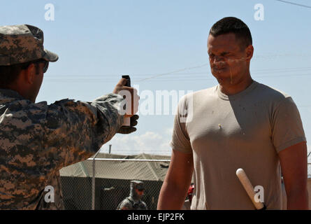 A Guardsman from B Company, 1st Battalion, 128th Infantry Regiment, 32nd Infantry Brigade Combat Team, is sprayed with Oleoresin Capsicum gas during detainee-operations training at McGregor Range, N.M.   Guard troops train with simulated Iraqi forces  /-news/2009/04/21/19933-guard-troops-train-with-simulated-iraqi-forces/l= Stock Photo