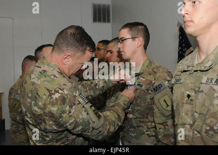 U.S. Army Maj. Gen. William Mayville, the commanding general of the 1st Infantry Division based out of Fort Riley, Kan., awards the purple heart to several Soldiers of the 3rd Brigade Combat Team, 1st Infantry Division, Task Force Duke, Oct. 25. After the awards ceremony, Mayville visited with key military leaders from TF Duke as part of an on ground walk through of the area. Stock Photo