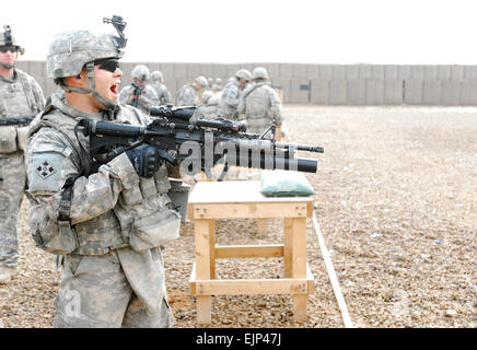 Sgt. Abraham Hernandez, infantryman assigned to Company B, 1st Battalion, 22nd Infantry Regiment, shouts before firing a non-lethal M203 round Jan. 9 during non-lethal weapons training at Forward Operating Base Falcon in southern Baghdad's Rashid district. Hernandez, who hails from Houston, and other 1st Raider Brigade Soldiers conducted training on non-lethal weapons, Rules of Engagement, and Escalation of Force. Co. B, 1st Bn., 22nd Inf. Regt., is part of the 1st Brigade Combat Team, 4th Infantry Division, Multi-National Division-Baghdad, currently serving a combat deployment in support of O Stock Photo