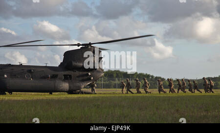 Army Rangers of 1st Battalion, 75th Ranger Regiment, prepare to enter an MH-47 helicopter to execute fast rope training at Hunter Army Airfield, Ga. June 2, 2014. US. Army  Spc. Coty Kuhn Stock Photo