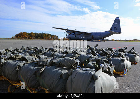 T-11 parachutes lie ready to be issued to paratroopers, assigned to 173rd Infantry Brigade Combat Team Airborne, to conduct a combat training jump from a C-130 Hercules into Bunker Drop Zone at the 7th Army Joint Multinational Training Command's Grafenwoehr Training Area, Germany, Oct. 22, 2013. U.S. Army  Visual Information Specialist  Gertrud Zacch/released Stock Photo