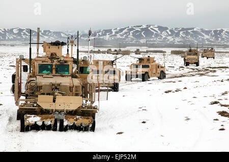 U.S. Army soldiers with Company A, 4th Brigade Special Troops Battalion, 4th Brigade Combat Team, 101st Airborne Division travel down route dodge during a route clearing procedure, Paktika province, Afghanistan, Feb. 10. The route clearing procedure was to deploy a mine clearing line charge to destroy possible improvised explosive device. Stock Photo