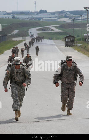 CAMP BONDSTEEL, Kosovo – Soldiers with Kosovo Force’s Multinational Battle Group-East compete in a  seven-mile ruck march as part of the German Armed Forces Proficiency Badge testing, Aug. 7. The badge, which is issued by the German army, tests participants in various physical fitness tasks and can be earned at the bronze, silver and gold levels. The badge can be earned and worn by U.S. service members.  Sgt. Cody Barber, 11th Public Affairs Detachment Stock Photo