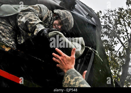 New Jersey Army National Guardsman Staff Sgt. Kenneth Williams hands sand bags out the back of a M35 2¬Ω ton cargo truck Oct. 29 in Atlantic City, N.J., in support of local residents during Hurricane Sandy. Williams along with other soldiers and airmen are operating out of the 177th Fighter Wing, New Jersey Air National Guard, located at Atlantic City International Aiport, N.J.  U.S. Air Force photo/Tech. Sgt. Matt Hecht Stock Photo