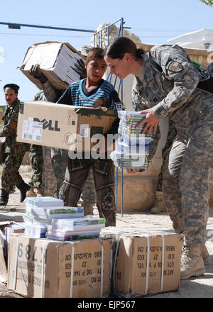 U.S. Army soldiers assigned to the 10th Mountain Division and Regional Support Command-North and Afghan National Army soldiers assigned to the 209th Corps hand out school supplies to Nawabad School in Deh Dadi district, Afghanistan, on Sept. 30 2010.  The school provides secondary education to nearly 1,000 students in the area despite shattered windows and deteriorated wooden ceilings.  The classes are so large the school rotates through three shifts each day to accommodate the students.   Sandra Arnold, U.S. Army Stock Photo