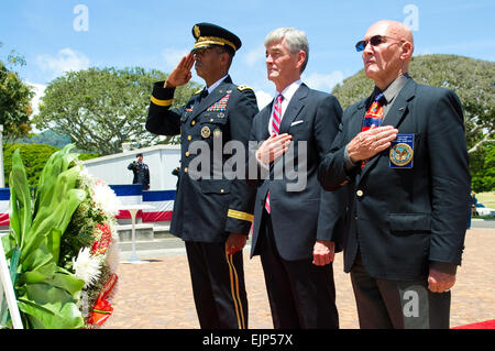 Secretary of the Army John McHugh, along with Gen. Vincent Brooks, Commanding General U.S. Army Pacific, and Gene Castagnetti, Director, National Memorial Cemetery of the Pacific, honor fallen U.S. service members at the National Memorial Cemetery of the Pacific, Honolulu, Hawaii during a wreath-laying ceremony, July 23, 2013. U.S. Army  Spc. John G. Martinez Stock Photo