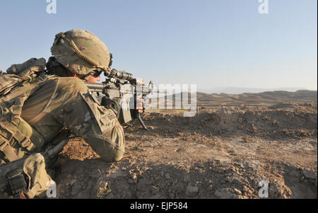 A U.S. Army soldier with Headquarters and Headquarters Battery, 1st Battalion, 84th Field Artillery Regiment, 170th Infantry Brigade Combat Team scans his sector during a security patrol Sept. 23. Soldiers with 1-84 Field Artillery provided security during the construction of a bridge and detour near the village of Ghormach. Stock Photo