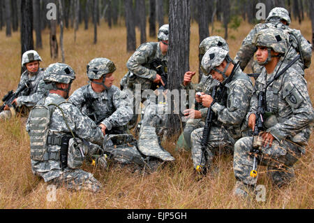 Members of 1st Battalion, 501st Parachute Infantry Regiment, Fort Richardson, Alaska, move out of the drop zone and set up a security perimeter after parachuting out of a U.S. Air Force C-17 Globemaster III aircraft and into the Shoalwater Bay training area, located in Queensland Australia, during exercise Talisman Saber, July 17, 2011.  Talisman Saber 2011 is an exercise designed to train U.S. and Australian forces to plan and conduct Combined Task Force operations to improve combat readiness and interoperability on a variety of missions from conventional conflict to peacekeeping and humanita Stock Photo