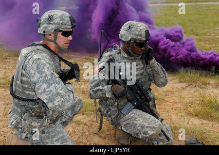 Georgia Army National Guardsman 2nd Lt. Tye Walden, platoon leader, relays radio traffic to Pvt. David Lemons during a live fire exercise at the Georgia Garrison Training Center, Fort Stewart, Ga. The platoon leader and radio operator relayed fire commands to the fire teams on the firing line during a combined arms live fire exercise at the 48th Infantry Brigade Combat Team's eXportable Combat Training Capabilities XCTC training at Fort Stewart. Army photo by Sgt. Michael Uribe Stock Photo