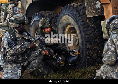 U.S. Army personnel provide security while overcoming a ground attack during a joint service field exercise, Joint Readiness Training Center, Fort Polk, La., Oct. 18, 2012. Service members at JRTC 13-01 are educated and evaluated in a simulated combat environment. Stock Photo