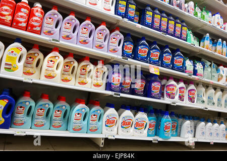 Shelves filled with Bottles liquid laundry detergent in a Carrefour Hypermarket in Belgium Stock Photo