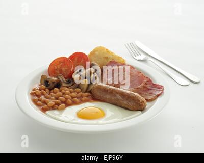 Full english Scottish Irish Welsh breakfast sausage fried egg bacon baked beans grilled tomatoes mushrooms hash brown on white Stock Photo