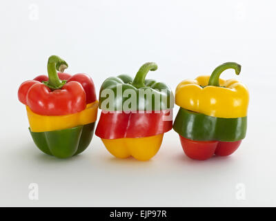 three peppers yellow red green sliced into three parts then placed back together as tricolour vegetables Stock Photo