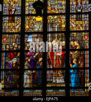 Stained Glass Window depicting Saint Lambertus anointing the Taxandrians during the Confirmation, the rite of initiation. Stock Photo