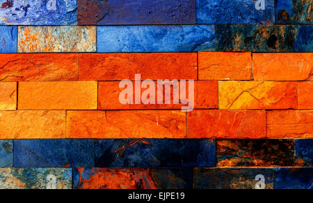 Colorful brick wall with many orange and blue nuances. Stock Photo