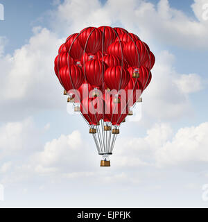Group concept as a team of red hot air balloons joined together as a symbol for teamwork unity and collaboration solidarity with people being lead by an individual manager. Stock Photo