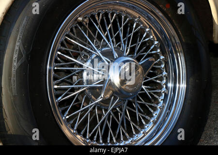 A spoked wire wheel on a vintage car. Stock Photo