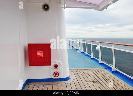 White painted wall of a luxury cruise ship exterior image, with fire hose reel on a wall. Stock Photo
