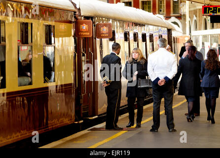 Uniformed Orient Express attendant with steam locomotive Stock Photo - Alamy