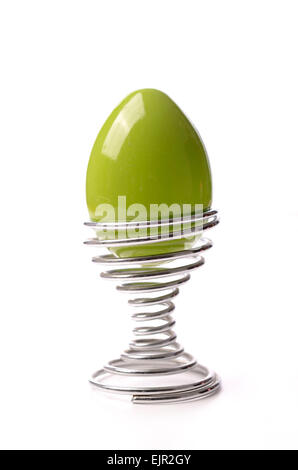 Green Easter egg in an eggcup on a white background Stock Photo