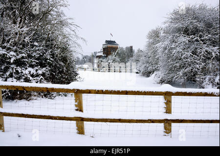 A view across snow covered field of Hook Norton Brewery in Oxfordshire Stock Photo