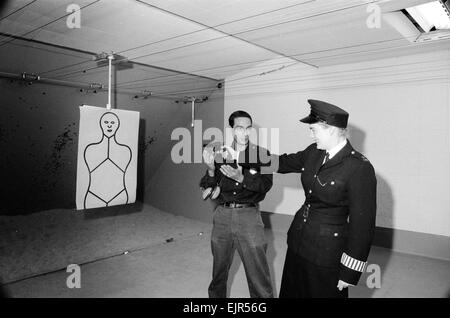 English police officers tour a firing range at a New York Police Department in America 2nd October 1964. Bobby is shown, by Instructor, how to hold a gun correctly *** Local Caption *** WatScan - - 05/01/2010 Stock Photo