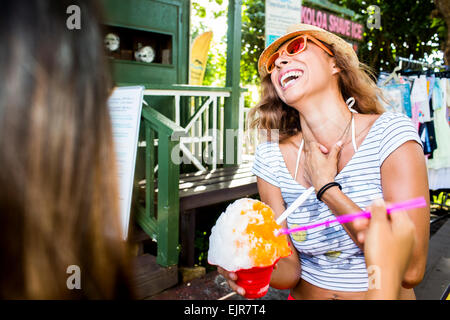 Laughing woman eating shaved ice