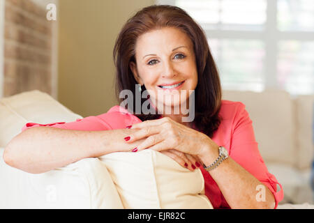 Older Caucasian woman sitting on sofa Stock Photo