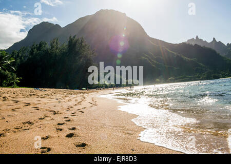 Footprints on sand near waves on tropical beach Stock Photo