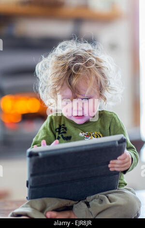 Caucasian baby boy using digital tablet Stock Photo