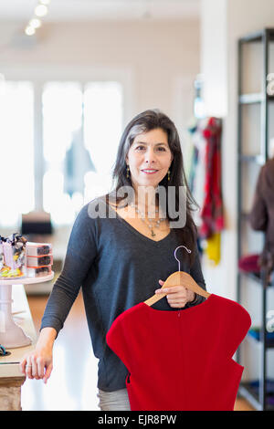 Hispanic small business owner working in store Stock Photo