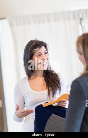 Small business owner talking to customer in store Stock Photo
